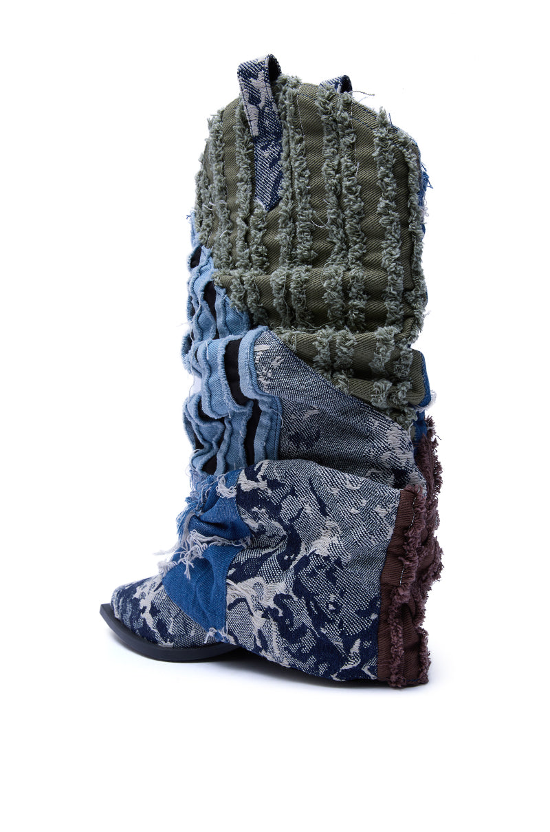 The AZALEA WANG GABRYLE MULTI MATERIAL WESTERN BOOTIE is a tall, slouchy denim boot with blue, green, and brown patchwork, visible seams, textured fabric, and a rugged look set on a chunky heel for extra edge.