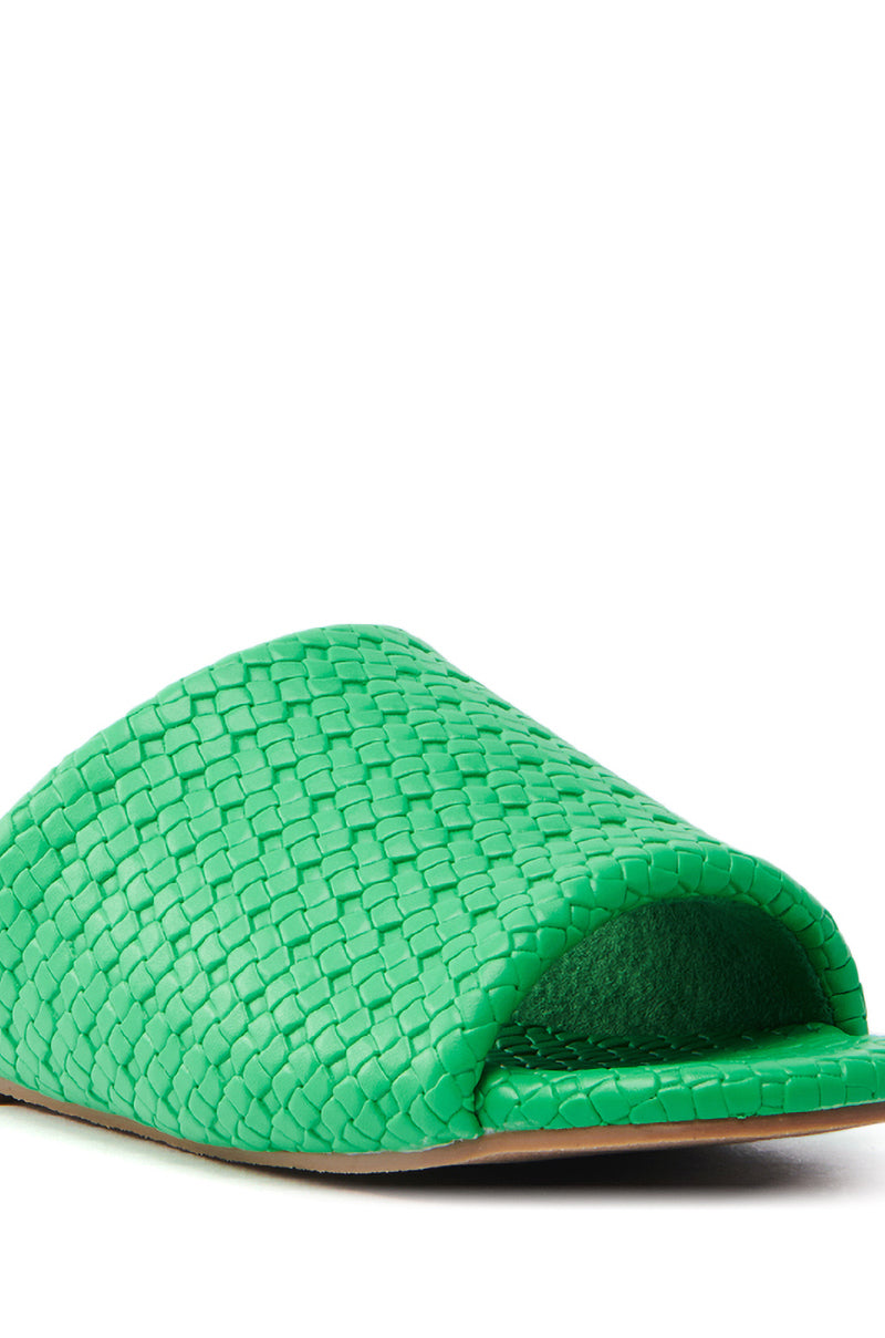 Close-up of the AKIRA GAIA GREEN BRAIDED FLAT SLIP ON SANDAL in faux leather, showcasing its open toe and intricate upper pattern in a side view against a plain white background.