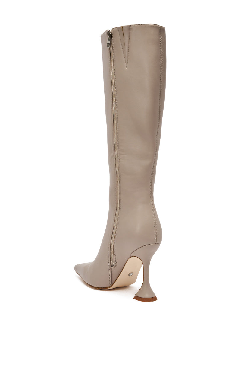 The AZALEA WANG GAMMA GREY CHUNKY KNEE HIGH BOOT features grey leather, a pointed toe, side zipper, and a striking chunky flared high heel. A light tan sole and modern silhouette distinguish this standout knee-high boot.