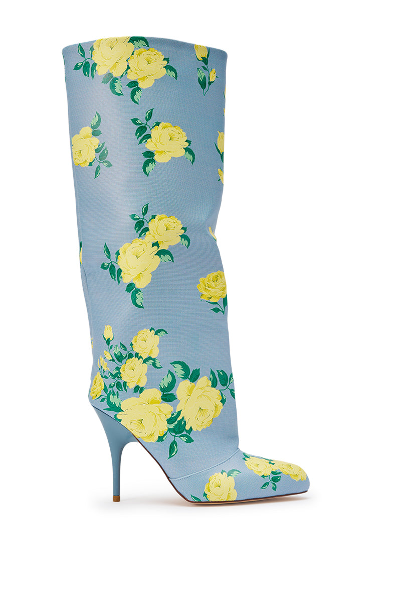 The AKIRA GOLD GARLAND BLUE FLORAL BOOT is a knee-high, pointed-toe stiletto crafted from blue faux leather with a bold yellow rose print, featuring a high slender heel and sleek, stylish design. 5
