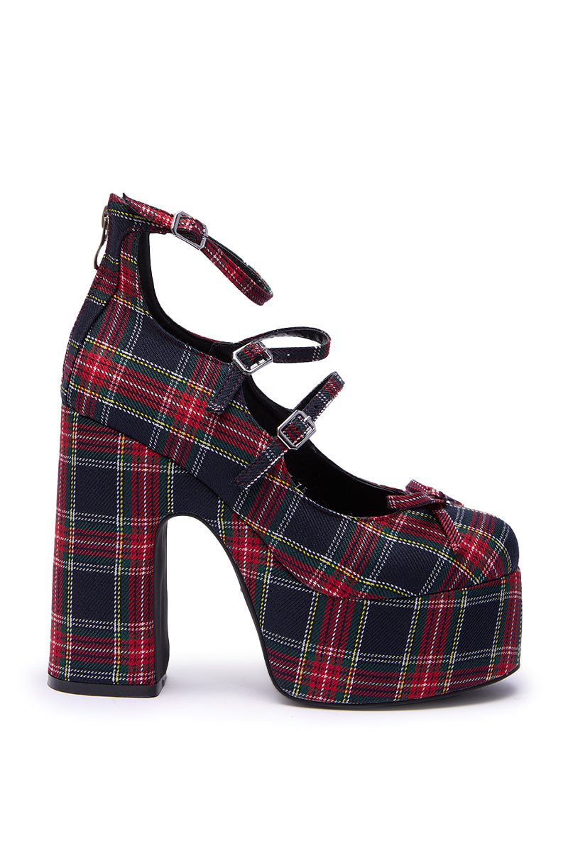 The AZALEA WANG GEORGINA MULTI PLAID CHUNKY PUMP features a bold red, green, and yellow plaid fabric, three buckle straps, a high chunky platform heel, and combines standout style with comfort.