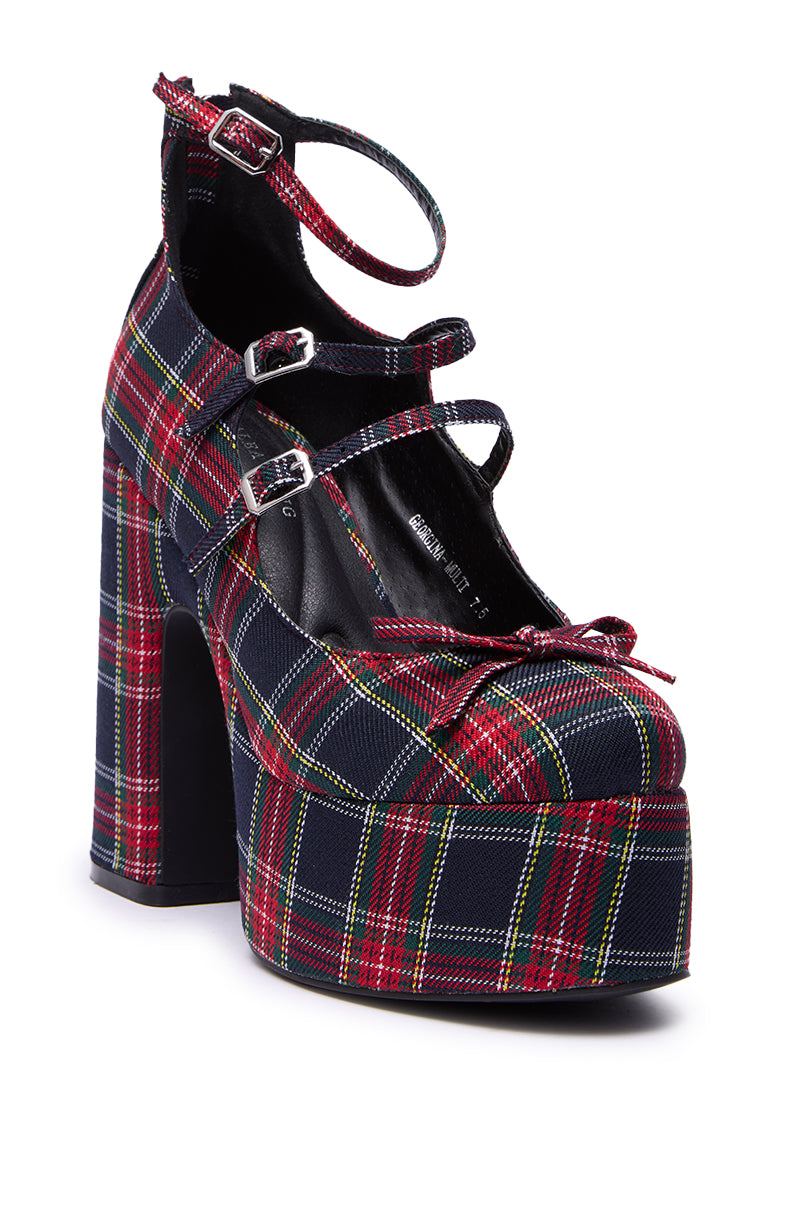 The AZALEA WANG GEORGINA MULTI PLAID CHUNKY PUMP features a bold red, green, yellow, and black plaid pattern, platform heel, and three buckled straps.
