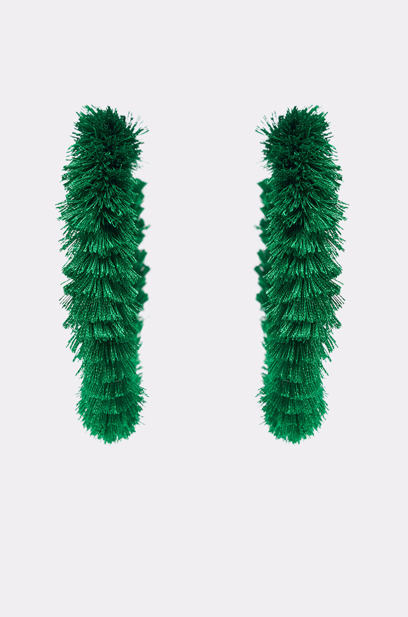 Two CARNIVALE EARRINGS, vibrant green and bristly, stand upright on a plain white background with space between them. 3