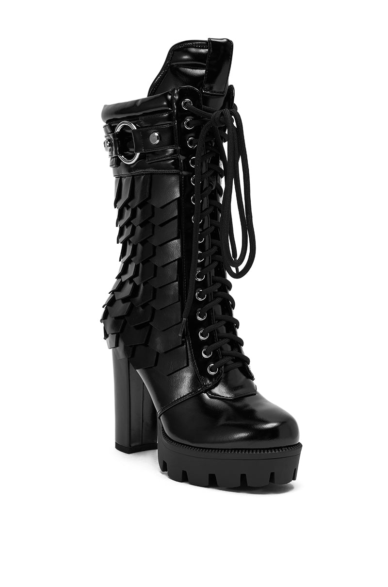 The AZALEA WANG GERNOT Black Lace Up Scaled Platform Bootie features a chunky sole, faux leather, layered textured panels, lace-up front, and a decorative side buckle for a bold and edgy statement look.
