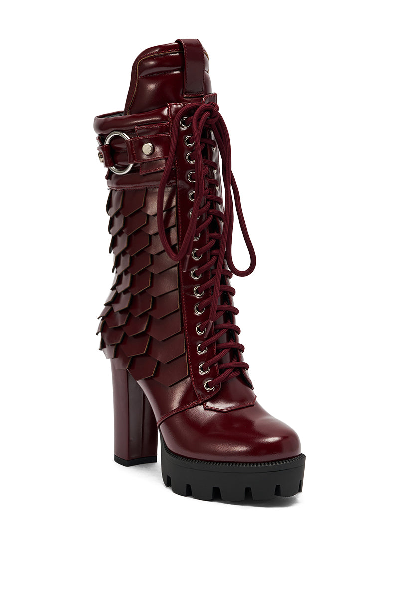 The AZALEA WANG GERNOT Burgundy Lace Up Scaled Platform Bootie features a single high heel, maroon color, black lug sole, front laces, and layered hexagonal faux leather panels for a textured, edgy look. 4