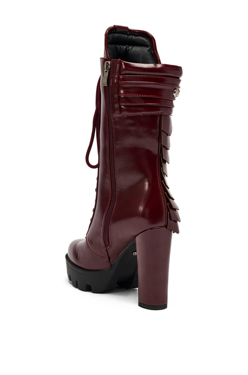 The AZALEA WANG GERNOT Burgundy Lace Up Scaled Platform Bootie features a high chunky heel, side zipper, black treaded sole, and layered back details. Shown from a rear side angle on a white background. 5