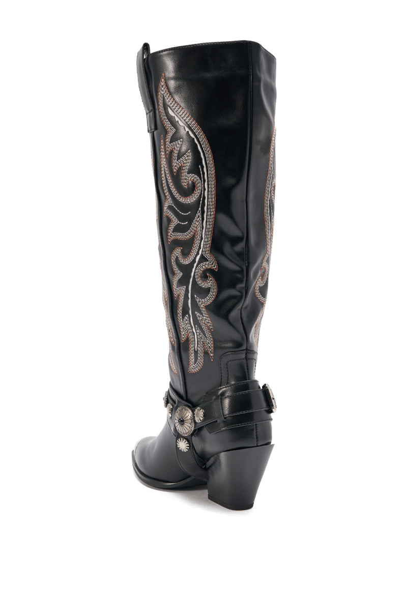 The AZALEA WANG GERVASE BLACK PU SILVER HARDWARE WESTERN BOOT features silver decorative stitching, a pointed toe, chunky heel, and a western-style spur strap with metal conchos, shown from the back. 5