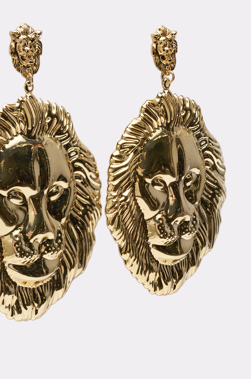 The ROAR EARRING set features gold-tone lion studs attaching to ornate lion-head drops with intricate manes, displayed on a plain white background. 3