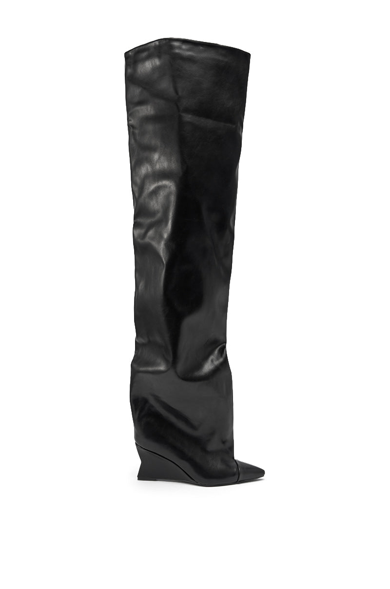 The AZALEA WANG GHANA OVER THE KNEE BLACK PU WEDGE BOOT is a black, over-the-knee pointed toe boot with a hidden low wedge heel, a relaxed slouchy fit, and a smooth glossy finish for modern style. 2