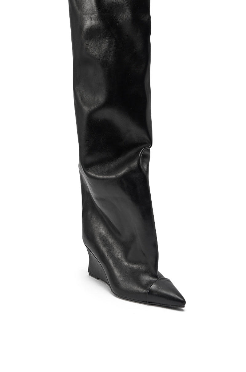 A close-up of the AZALEA WANG GHANA OVER THE KNEE BLACK PU WEDGE BOOT, featuring black faux leather, a pointed toe, and a low wedge heel, shown against a white background. 5