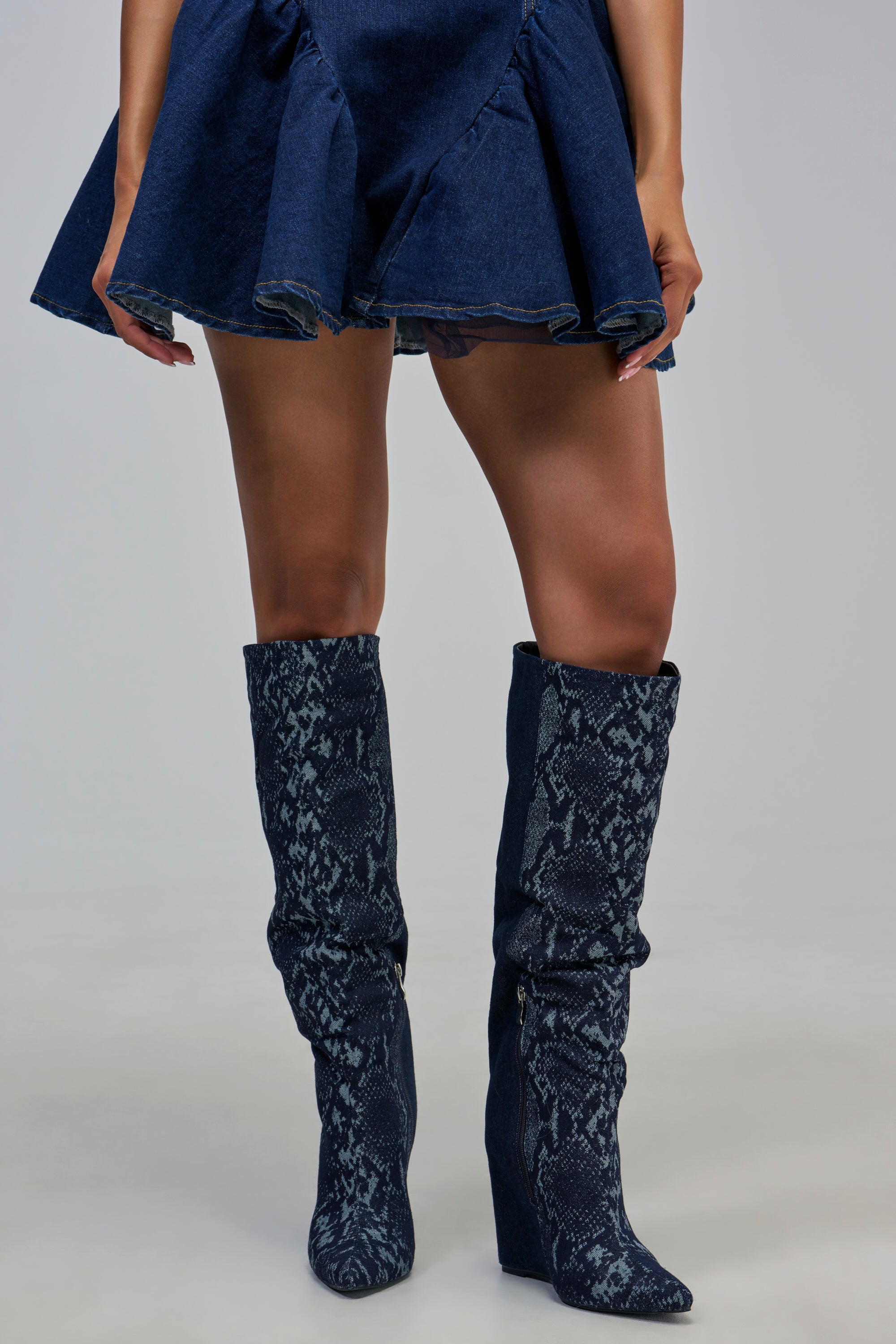 AZALEA WANG GIANNA DENIM WEDGE COLOR BLOCKED BOOT featuring knee-high denim wedge boots with a dark blue snakeskin print.