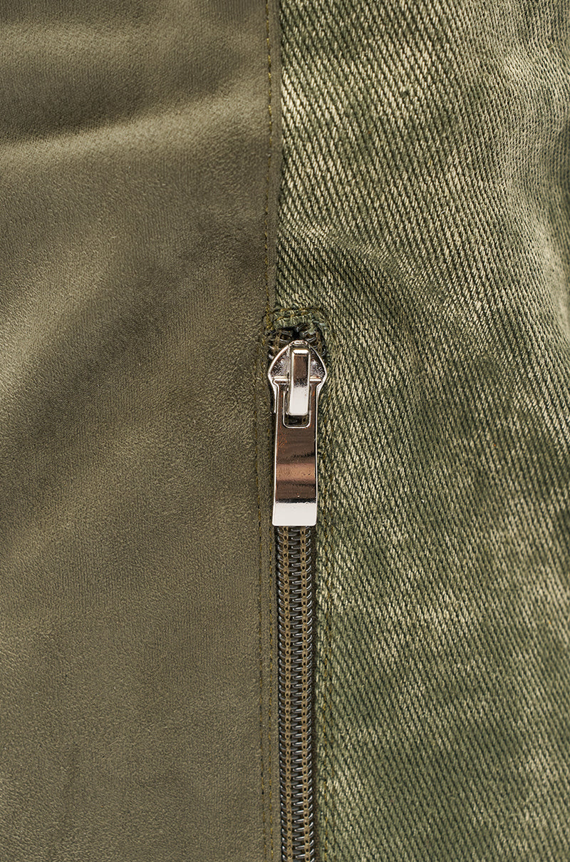 Close-up of a silver zipper on green fabric with contrasting textures, similar to the detailed stitching on the AZALEA WANG GIANNA OLIVE TWO TONED BOOT. 6