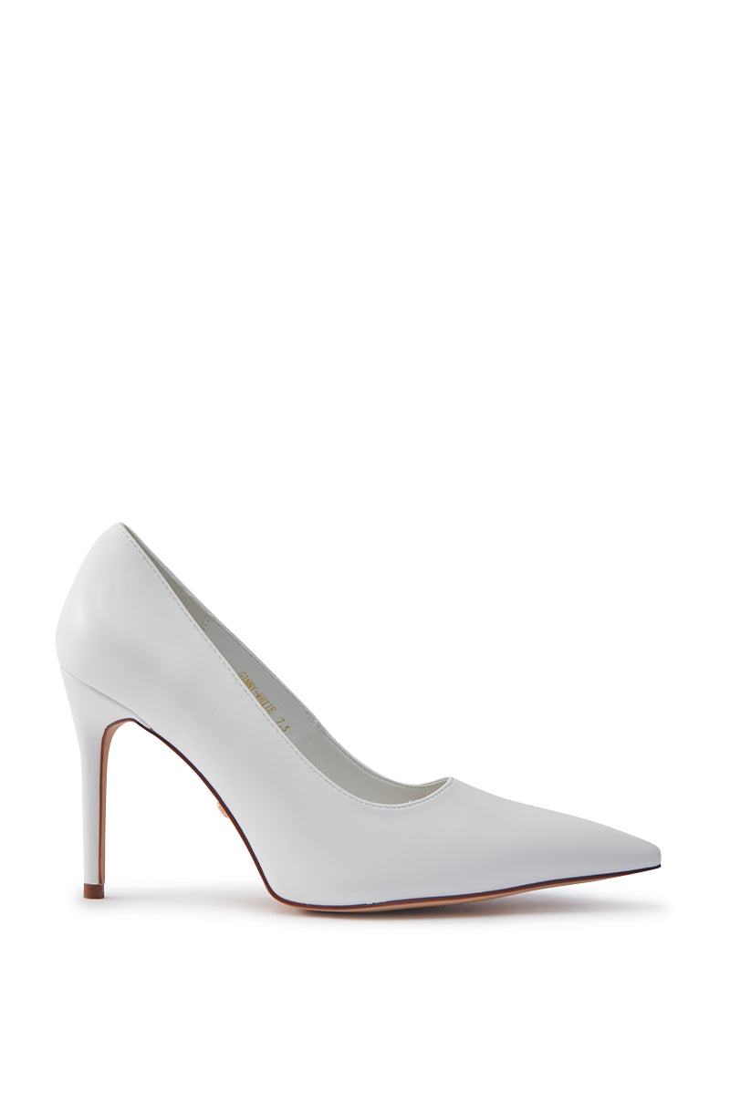 The AKIRA GINNY WHITE PUMP is a high-heeled shoe with a pointed toe and stiletto heel on a plain white background, featuring a faux leather upper for a sleek, elegant look. 3