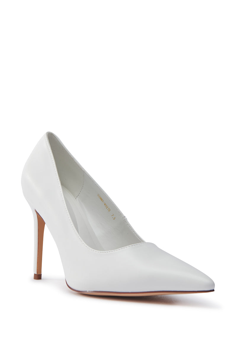 The AKIRA GINNY WHITE PUMP is a single high-heeled shoe with a pointed toe, slim stiletto heel, and smooth, glossy faux leather upper on a plain white background, showcasing an elegant design. 4