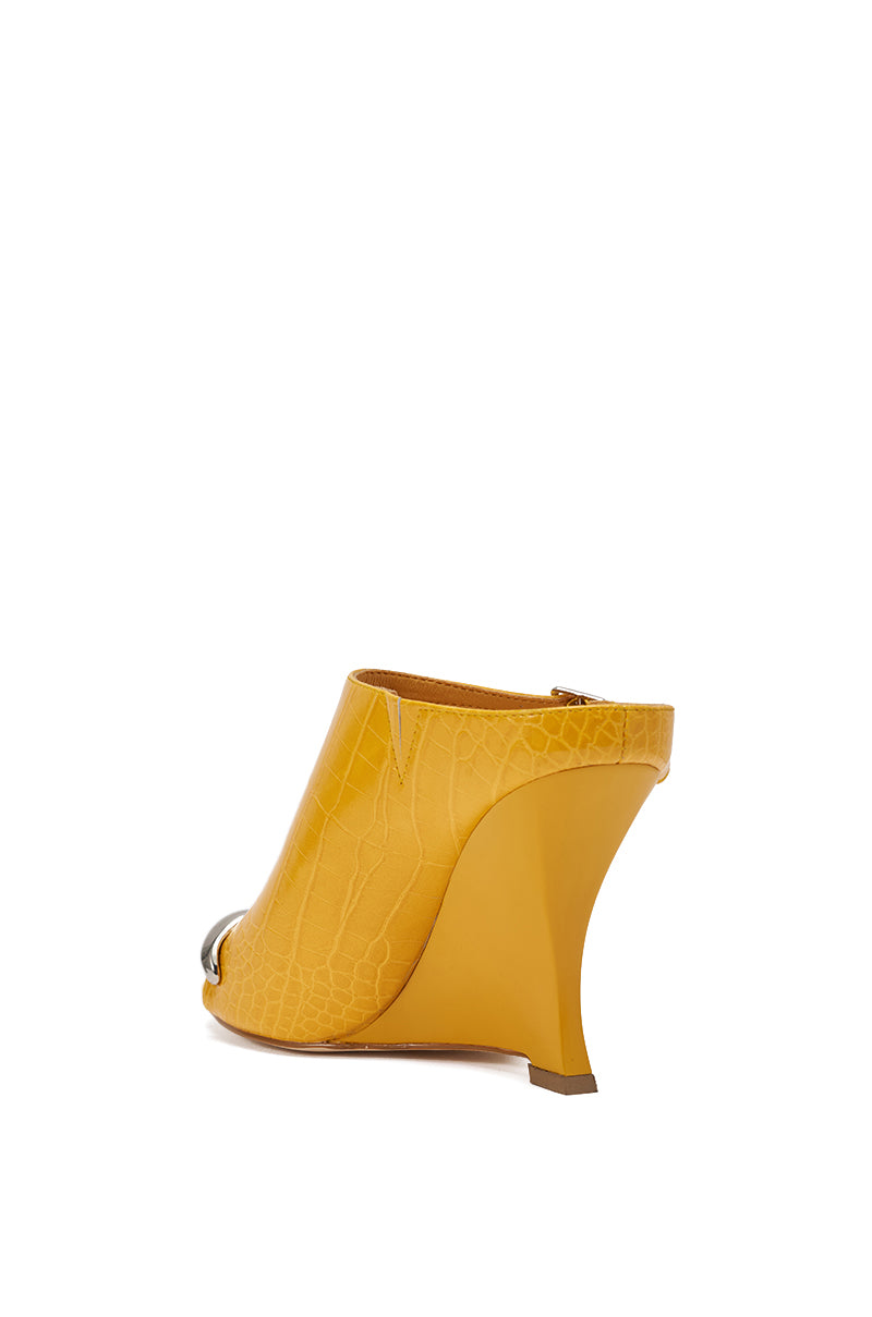 The AKIRA GOLD GINO MUSTARD CROC WEDGE SANDAL features yellow croc-embossed faux leather, an open toe, sculpted curved wedge heel, metallic toe accent, and a comfort cushion insole for extra support. 5