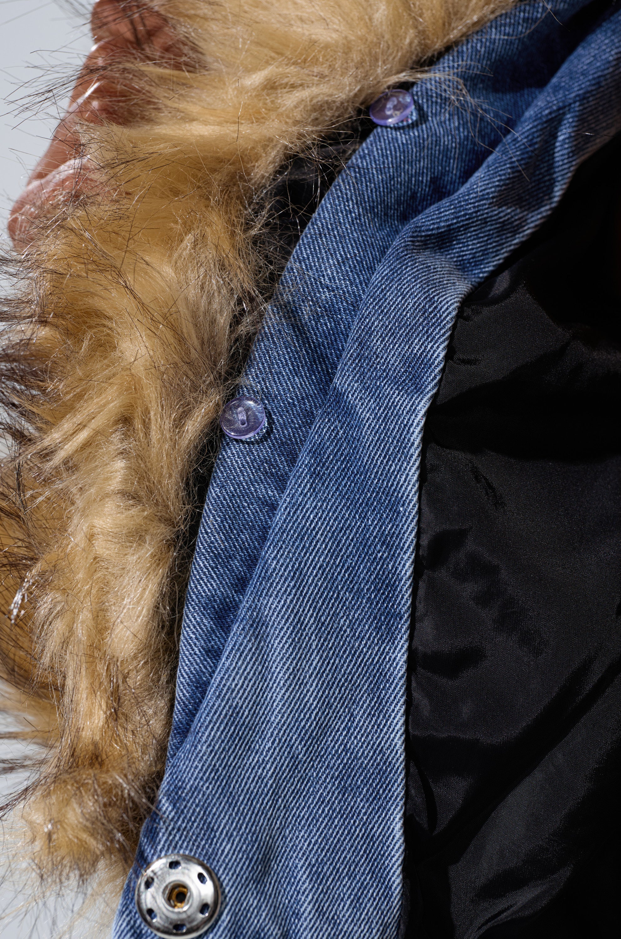Close-up of the NEW GISELE CROPPED FUR TRIM JACKET, a Y2K-inspired denim piece with faux fur collar and silver snap button, partially open to show black lining—ideal for capturing Bratz Doll style.