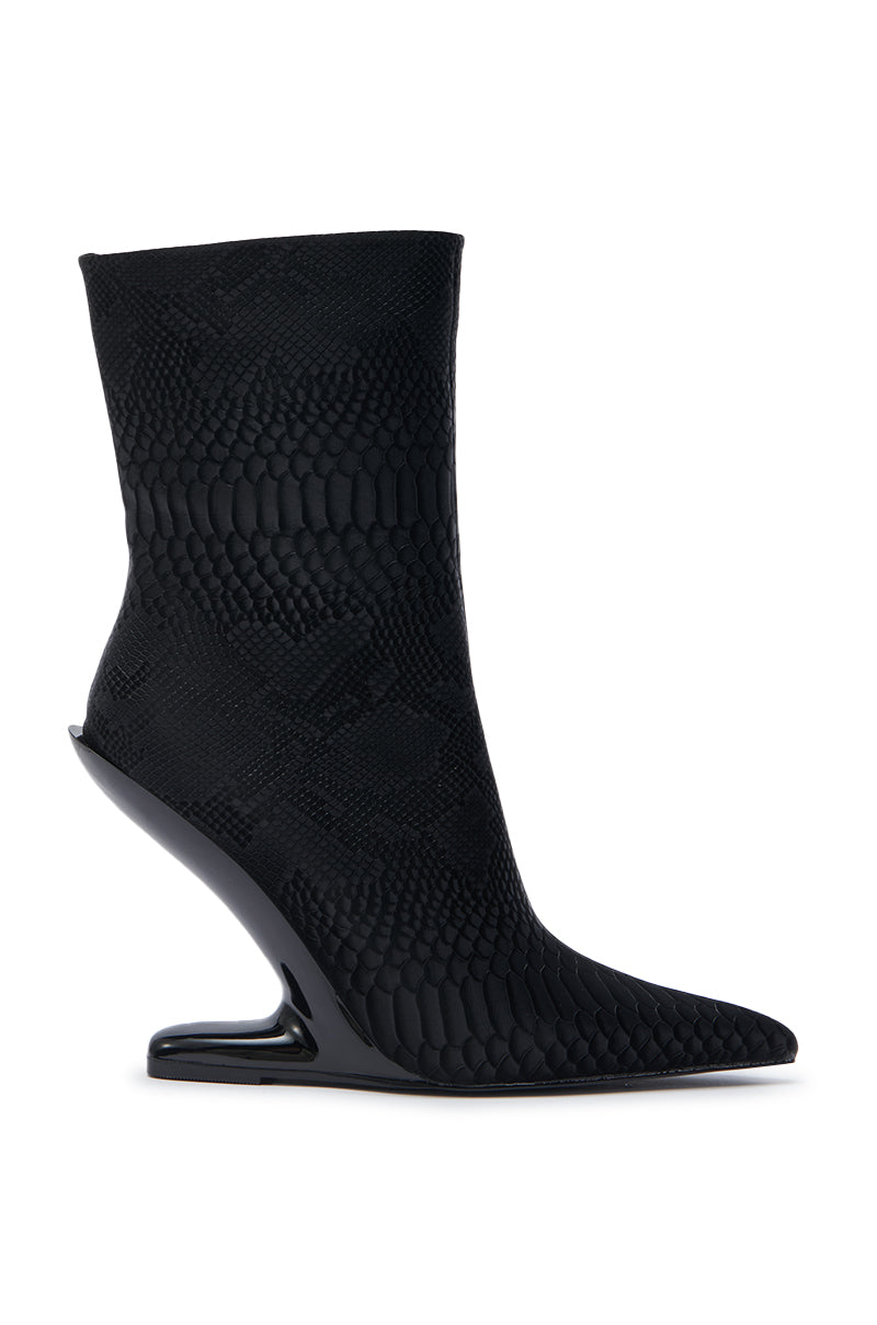 The AZALEA WANG GLACIELLE BLACK CROC BOOTIE features a black croc pattern, pointed toe, and a sculptural inverted heel that extends diagonally under the arch for a unique, futuristic look.