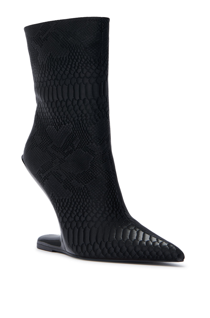 The AZALEA WANG GLACIELLE BLACK CROC BOOTIE is a sleek mid-calf boot with a pointed toe, wedge heel, and textured black croc pattern.