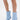 Wearing the AZALEA WANG GLACIELLE BLUE WEDGE BOOTIE with a pointed toe, sculptural wedge heel, and side zippers, a person stands against a white backdrop.
