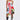 A woman stands confidently in the STAND OUT GRAPHIC MINI DRESS, featuring vibrant fabric patches with bold stripes and numbers, paired with black knee-high lace-up boots—a fresh street style look set against a plain white background.