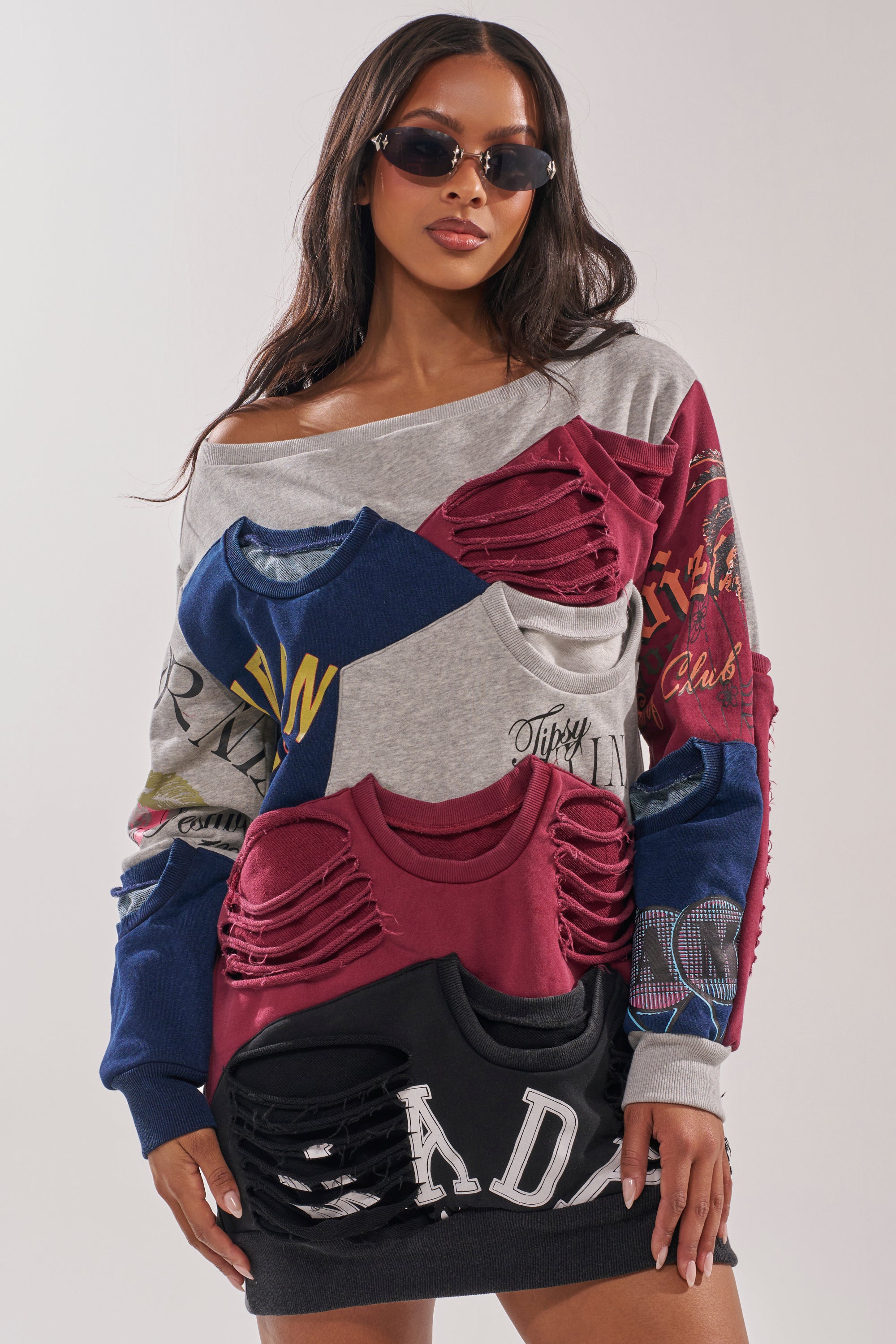 A woman in the TALK LATER OFF THE SHOULDER PATCHWORK DRESS with cut-out, layered off-shoulder details and sunglasses stands against a light background. 1