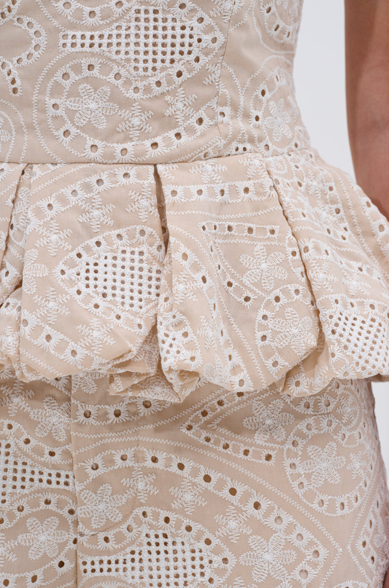 Close-up of the SUMMER TIME BLISS EYELET CORSET in beige, featuring embroidered eyelet patterns and a peplum waist. Delicate circular and floral designs add elegance, making it perfect for summer. 6