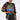 A woman in oversized sunglasses, the OFF TO THE RACES DISTRESSED OVERSIZED TEE, metallic leggings, furry black leg warmers, and holding a small multicolored bag stands against a plain white background.