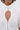 A person wearing the TOO COOL FOR YOU LACEUP BLOUSE, a white top with puffed sleeves, a teardrop-shaped chest cutout, decorative silver clasps, visible seams, and a subtle corset-style design.