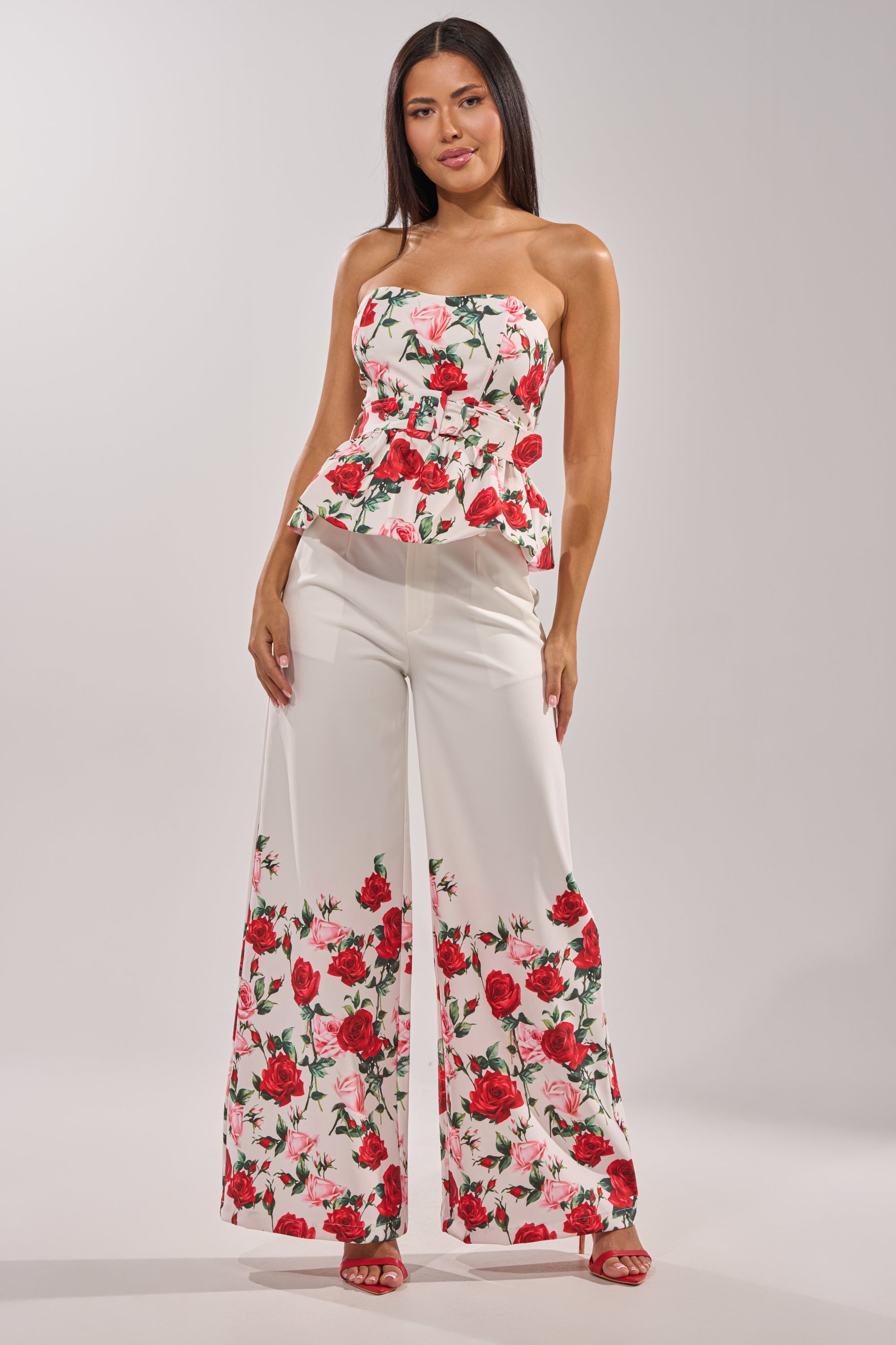 A woman wears the FULL BLOOM FLORAL TROUSER with a matching top. 0