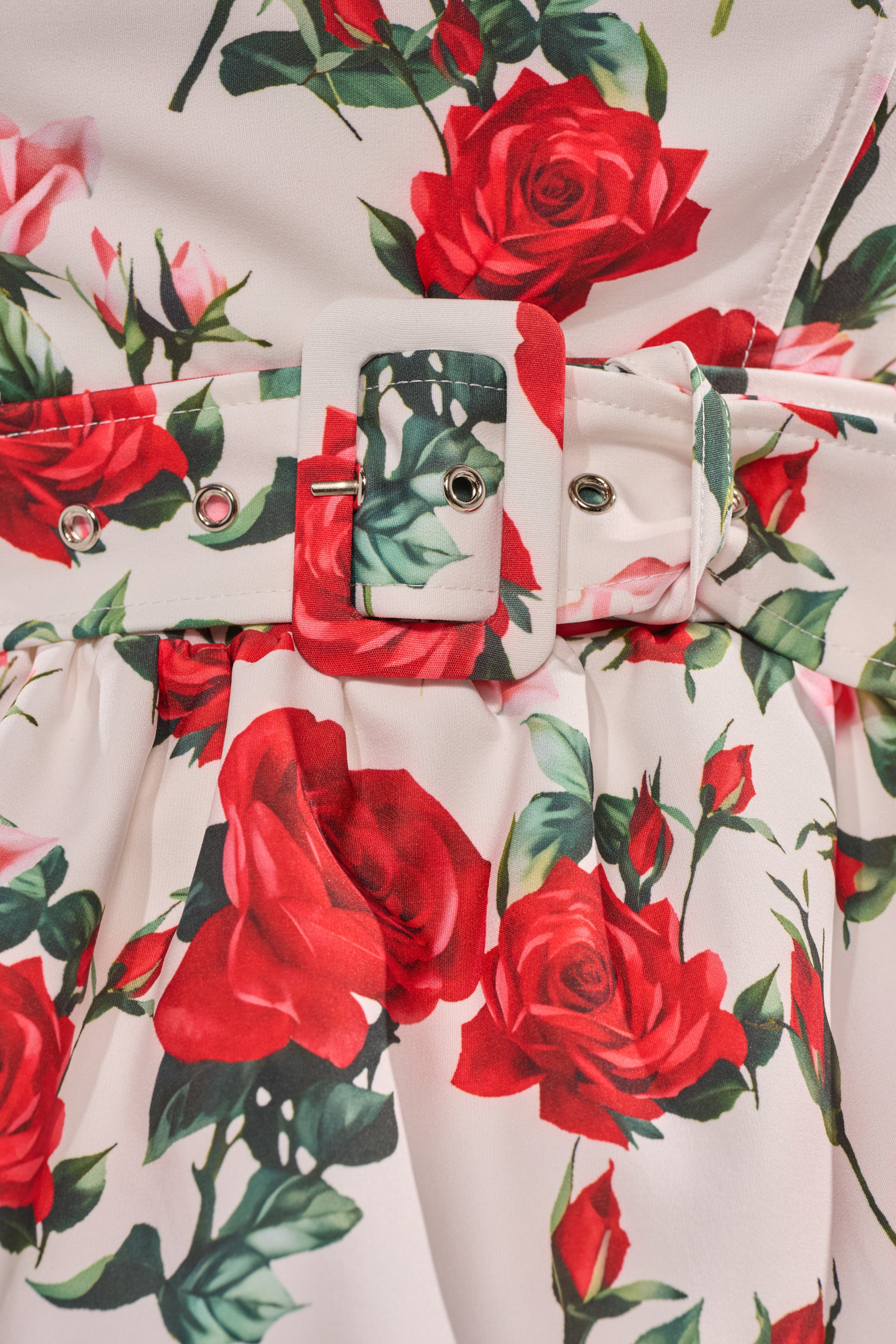 A close-up of the FULL BLOOM FLORAL CORSET shows a gathered waist, soft fabric folds, and a rectangular buckle belt. The corset features a rose print design on a white background. 8
