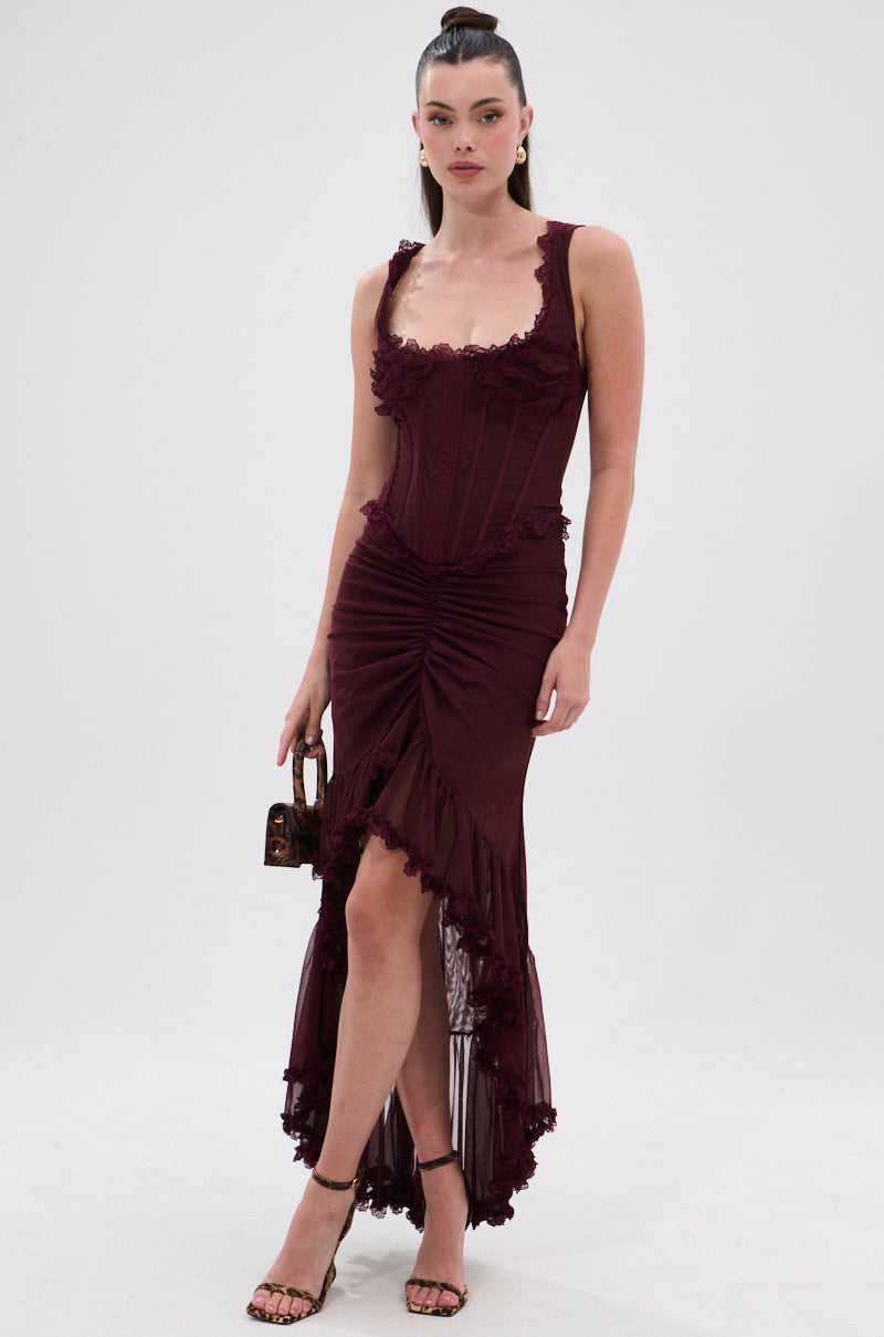 A woman wears the LOVELY DAYS MESH CORSET, styled with a small handbag and strappy high-heeled sandals, posing against a plain white background. 4