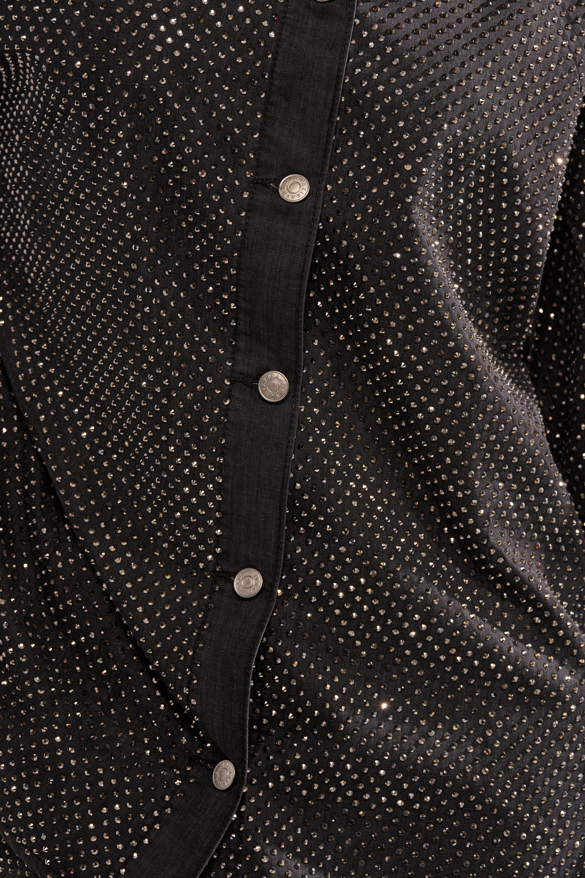 Close-up of the BLING BLING DENIM BUTTON DOWN TOP IN BLACK featuring silver metallic stud embellishments and five round silver buttons along the front placket. 8