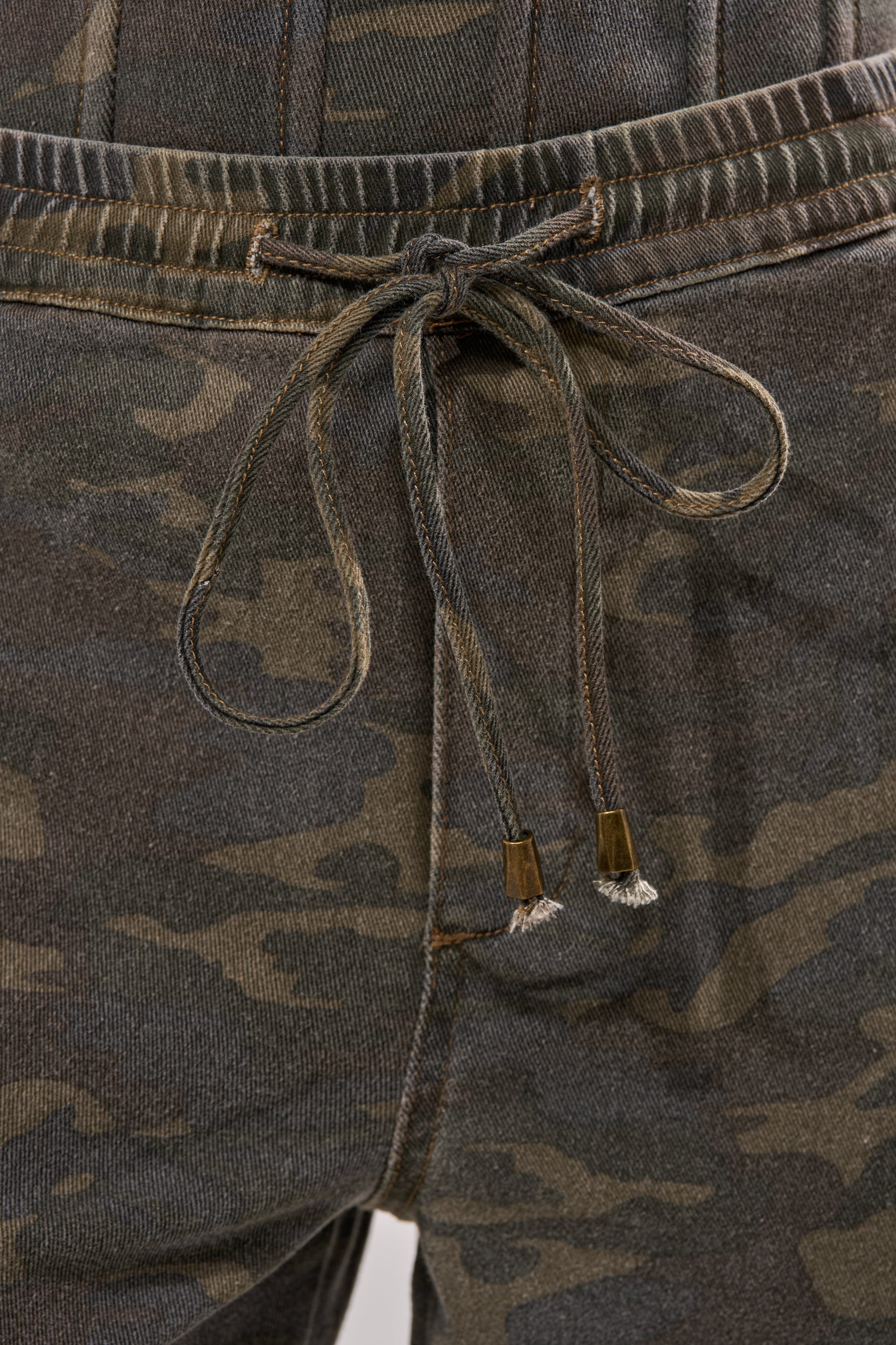 Close-up of DOWN AND DIRTY CARGO PANT showcasing a drawstring waist with knotted ends and a wide-leg silhouette. 8