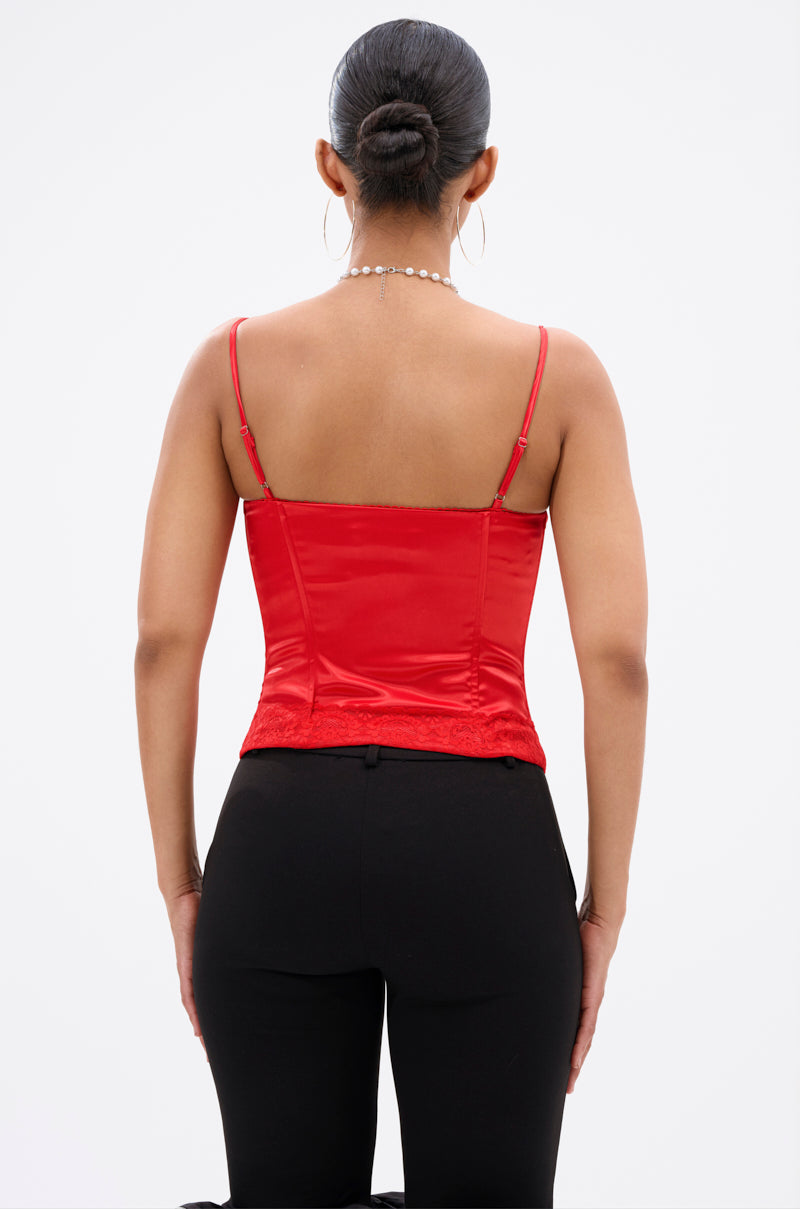 A woman with dark hair in a bun models the EXQUISITE SATIN LACE CORSET in red, featuring structural boning, paired with black pants. She is shown from the back against a white background, accessorized with hoop earrings and a delicate necklace. 4
