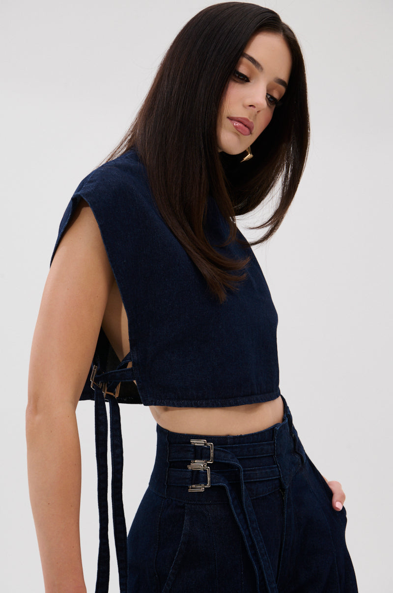 A woman with straight, dark hair wears the YOU A REAL ONE DENIM BLOUSE and matching high-waisted pants with double buckles, standing against a plain light background.