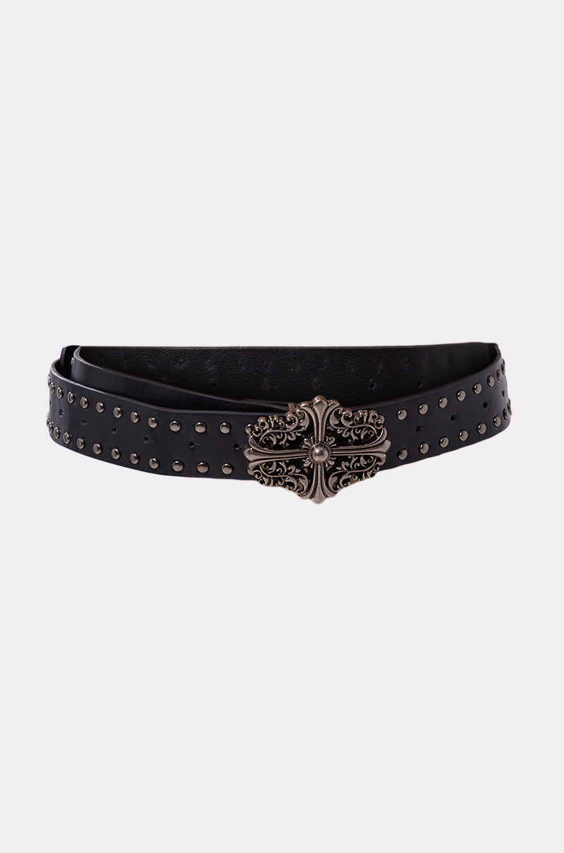 The CROSS ME BELT is a punk rock accessory made from black faux leather, detailed with small metal studs and an ornate antique-style silver buckle, shown on a plain light background.