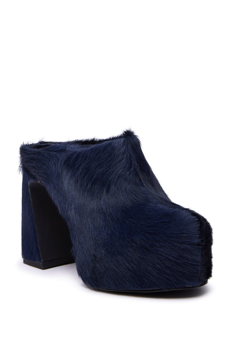 The AZALEA WANG GOLDING NAVY PONY HAIR CHUNKY PUMP is a high-heeled platform mule with dark blue faux pony hair, a chunky block heel, rounded toe, and bold platform sole. 5