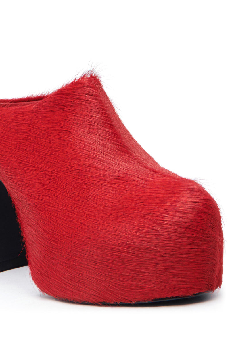 A close-up of the AZALEA WANG GOLDING RED PONY HAIR CLOG PUMP shows its bold platform sole and chunky black heel, with bright red pony hair material covering the upper.