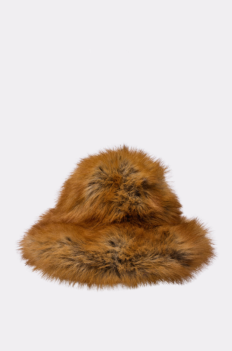 The HOT GIRL FAUX FUR OVERSIZED BUCKET HAT features brown faux fur with black streaks, making it a cozy winter accessory, shown against a plain light gray background.