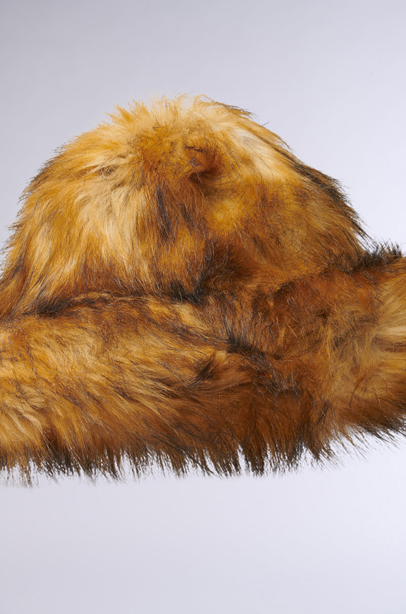 A close-up of the GRACELLE Oversized Faux Fur Bucket Hat in Brown against a plain background. The hat features a round shape with visible texture, showcasing elegant, rich shades of orange and brown that mimic the look of natural fur.