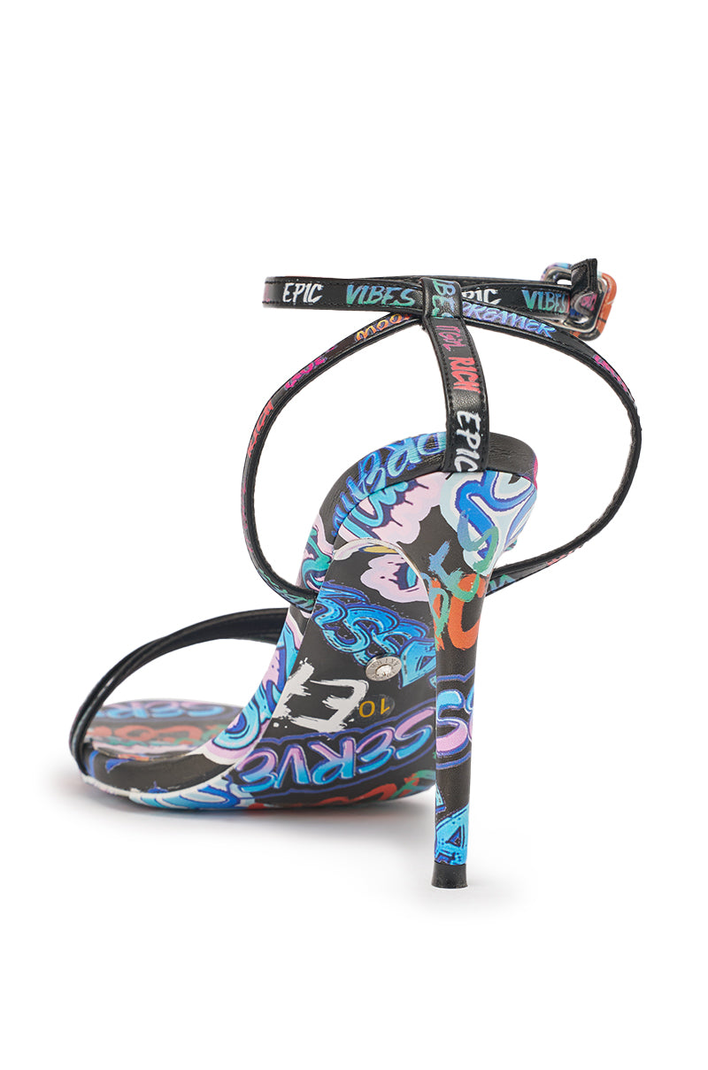 The AKIRA GOLD GRAFFITI PRINT STILETTO SANDAL features colorful graffiti-print straps and sole, a buckled ankle strap, and a tall stiletto heel—perfect for making a statement at any party. 4