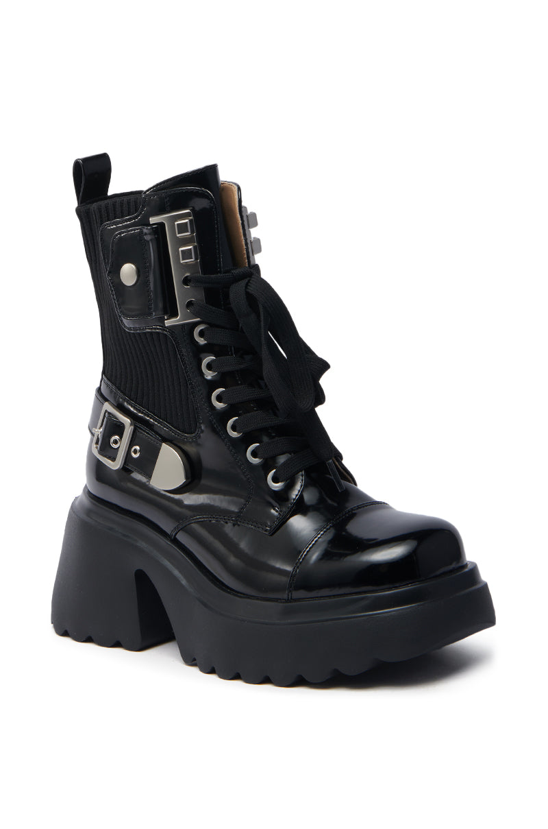 The AZALEA WANG GRAY BLACK WITH METAL PLATFORM BOOTIE is a black, high-top bootie featuring chunky tread soles, metallic accents, a buckle, and lace-up front. Its glossy finish and ribbed ankle fabric add an edgy vibe.