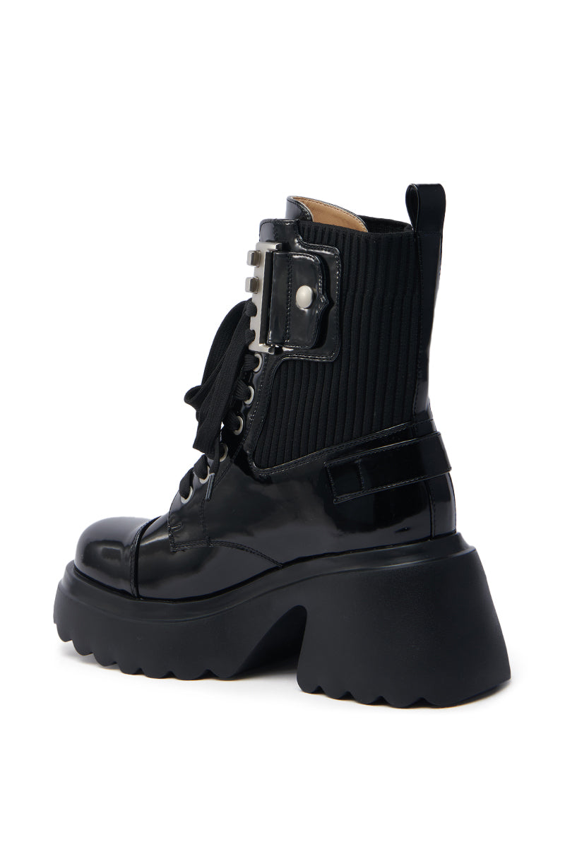 The AZALEA WANG GRAY BLACK WITH METAL PLATFORM BOOTIE is a glossy black combat boot made from faux leather, featuring a thick chunky sole, ribbed ankle detailing, lace-up front, back pull tab, a side pocket with buttoned flap, and a sturdy slightly elevated heel.