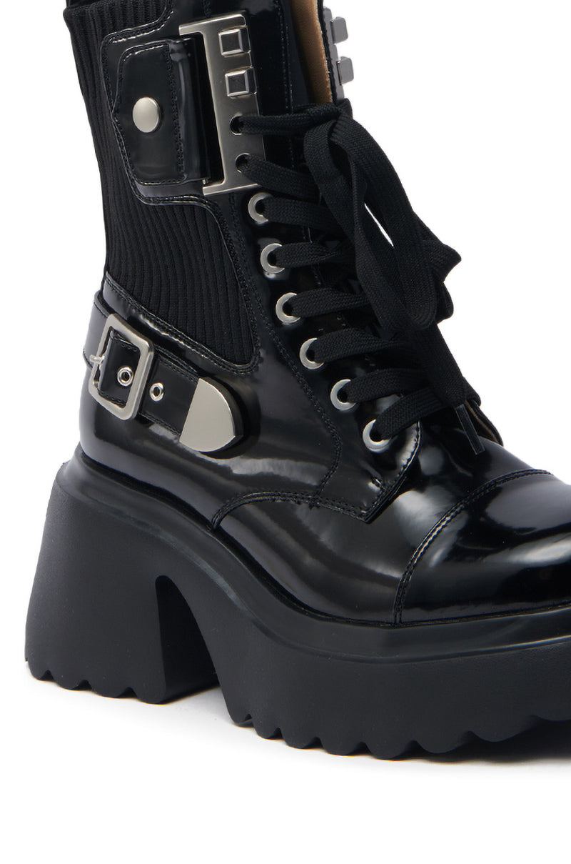 The AZALEA WANG GRAY BLACK WITH METAL PLATFORM BOOTIE features a shiny black combat design with a chunky metal platform sole, lace-up front, ribbed fabric ankle section, silver buckle, and side metal square accents for a sleek faux leather look.