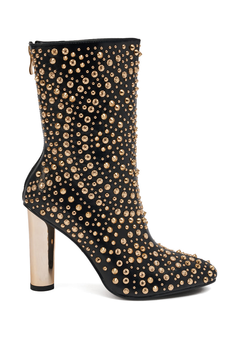 The AZALEA WANG GREHGAN BLACK EMBELLISHED CHUNKY HEEL BOOTIE features black material with gold studs and rhinestones, a metallic gold chunky block heel, and a convenient side zipper for easy wear.