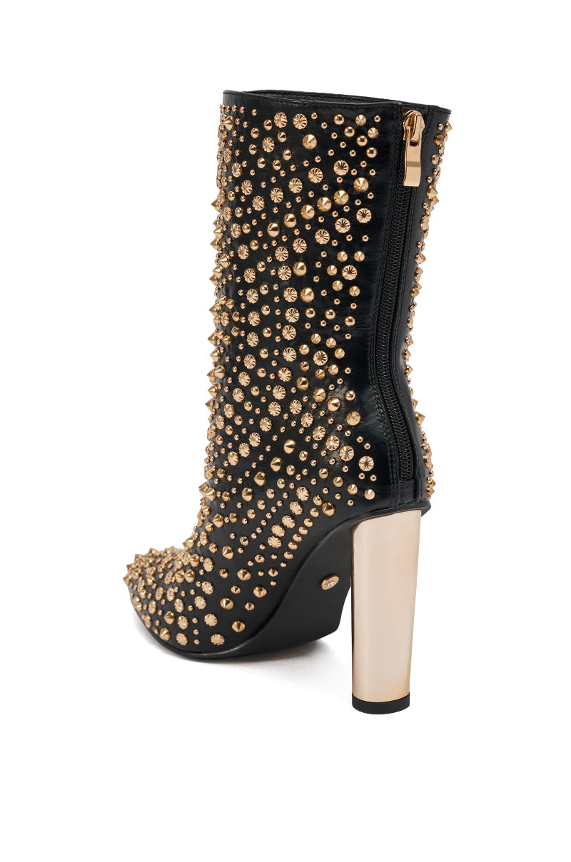 The AZALEA WANG GREHGAN BLACK EMBELLISHED CHUNKY HEEL BOOTIE features gold studs, rhinestones, a side zipper, and a bold metallic gold chunky heel for standout style.
