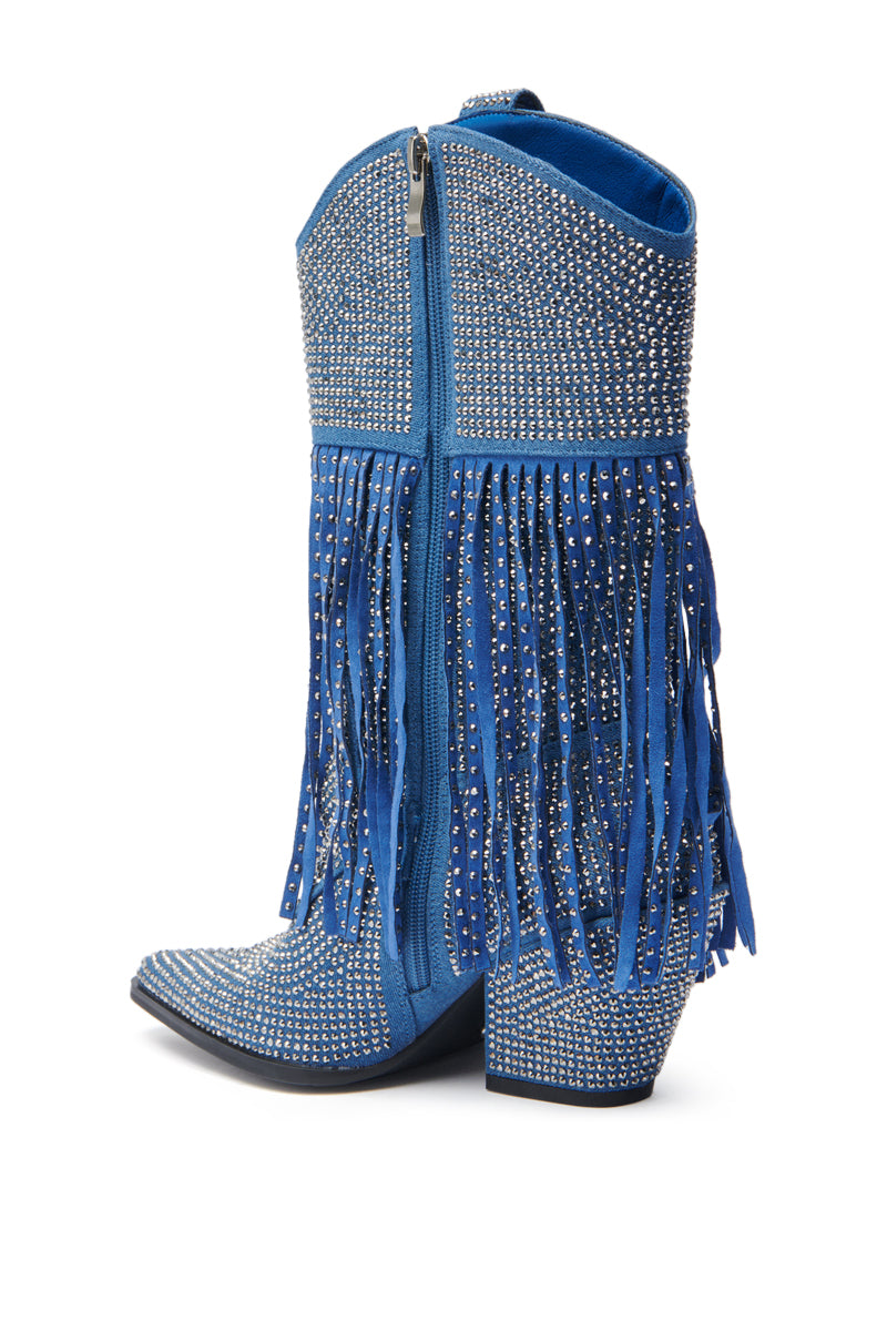 The AZALEA WANG GREIA DENIM RHINESTONE COWBOY BOOTIE features blue denim, a high heel, rhinestone embellishments, Western stitching, fringe accents, and a side zipper. Shown from the side against a white background.