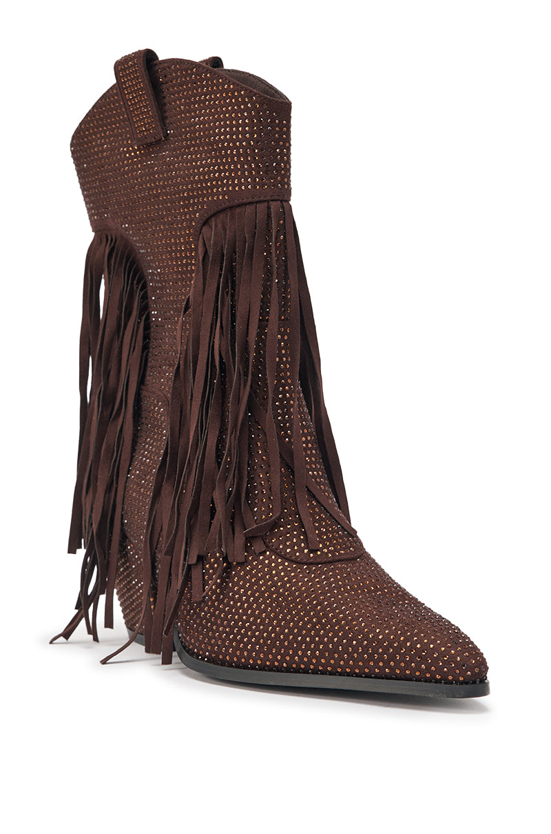 The AKIRA GOLD GREIANA BROWN RHINESTONE WESTERN BOOTIE features brown suede, a pointed toe, decorative rhinestone studs, and long side fringe detailing, showcased against a white background. 4