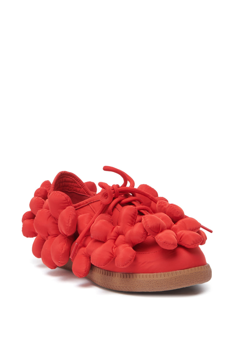 The AZALEA WANG GREYI RED PUFF FLORAL FLAT SNEAKER features a bright red design with puffy, rounded floral accents, matching red laces, and a light brown rubber sole.