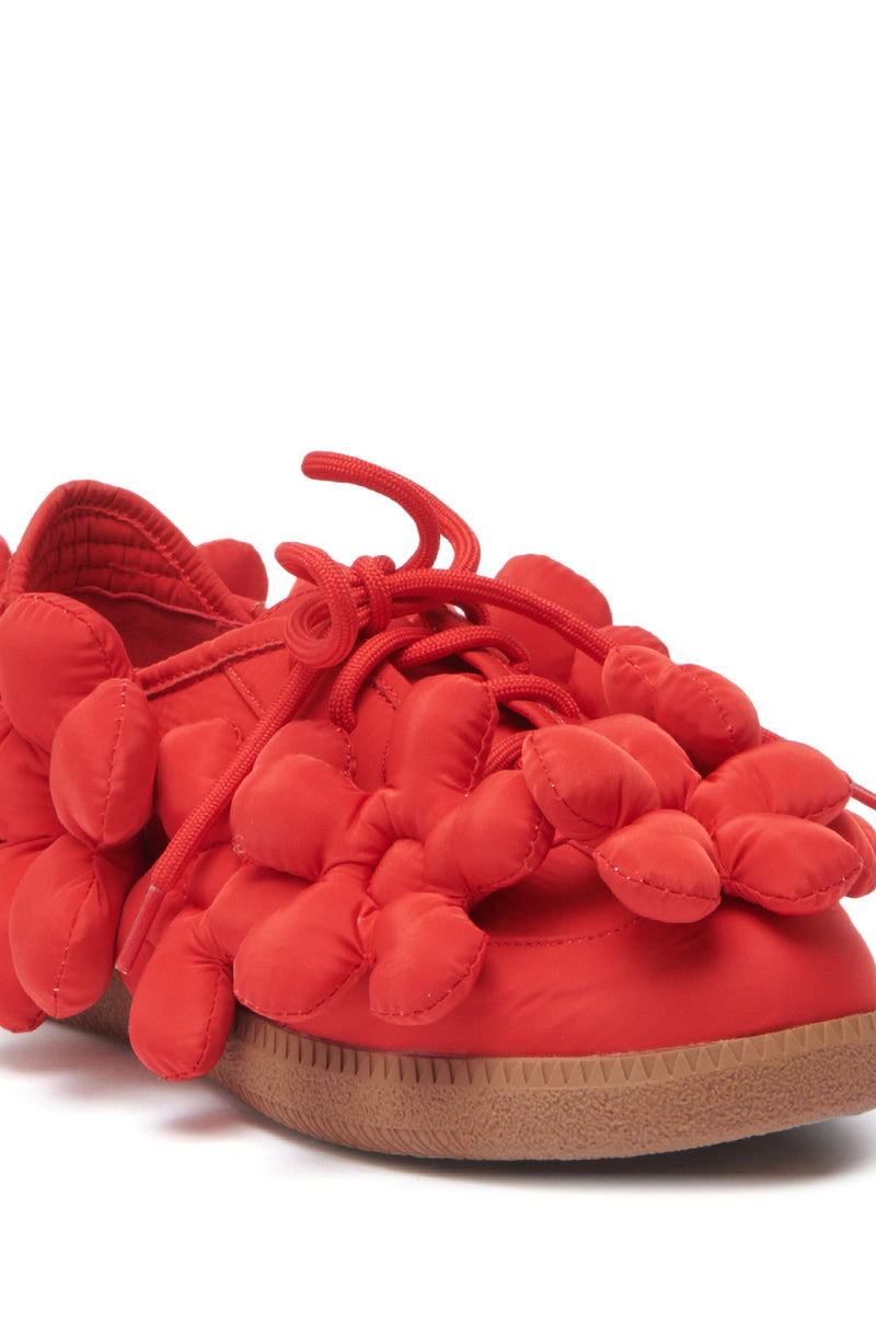 The AZALEA WANG GREYI RED PUFF FLORAL FLAT SNEAKER features bright red tones, puffy floral appliques, a brown rubber sole, and matching red laces for a playful, standout style.